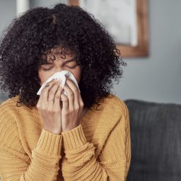 Woman with a cold sneezing