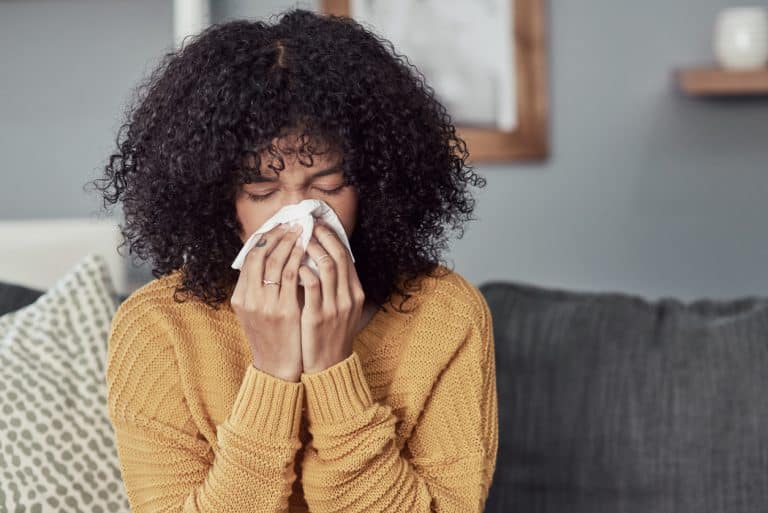 Woman with a cold sneezing