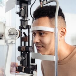 Young man receiving an eye exam to test for glaucoma.