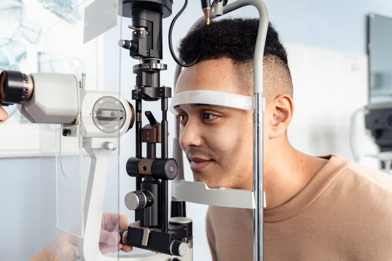 Young man receiving an eye exam to test for glaucoma.